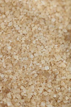 Close-up of brown sugar crystals known as gula semut in packaging.