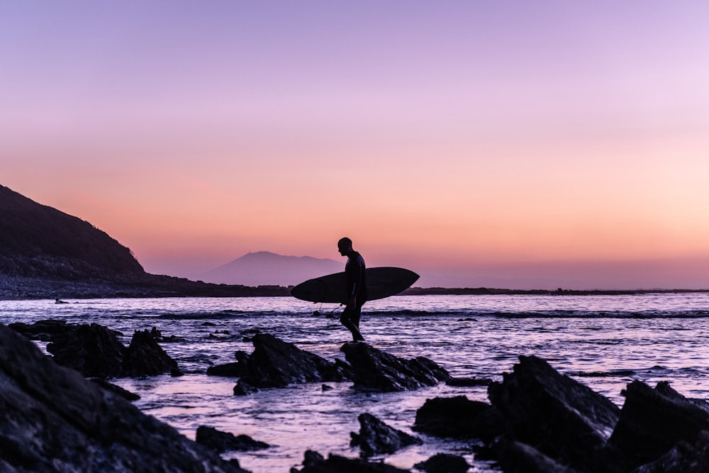 man holding surfboard