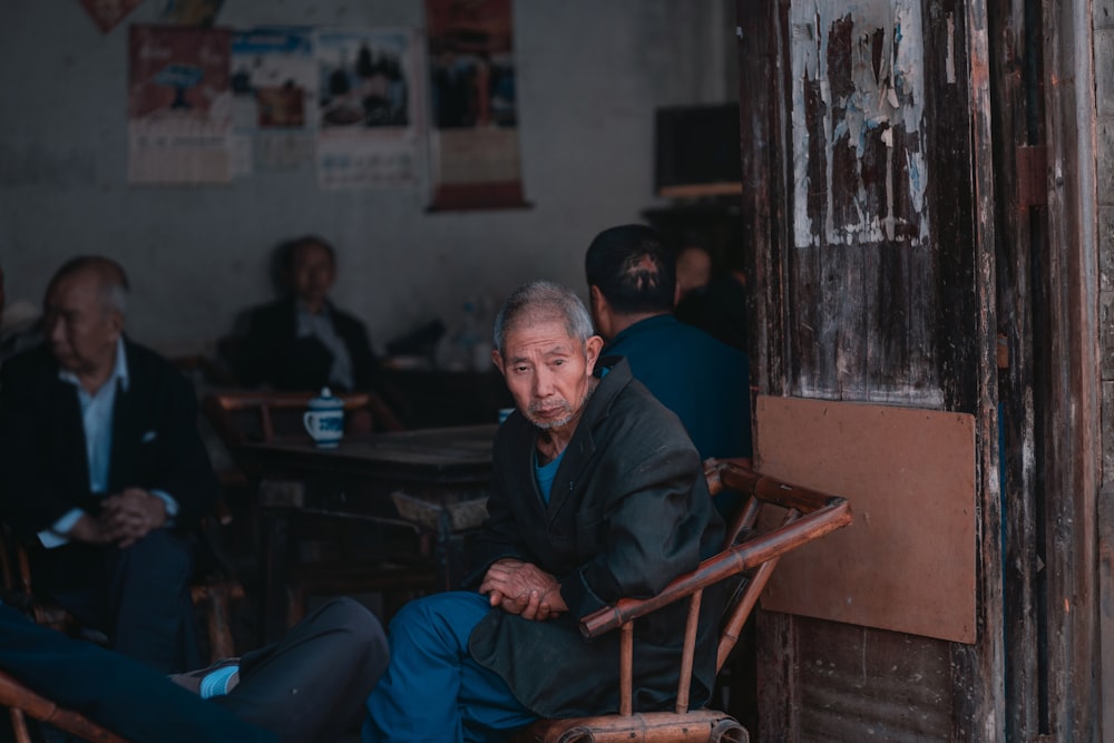 men sitting on rattan sofa