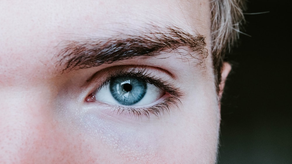 man's blue left eye