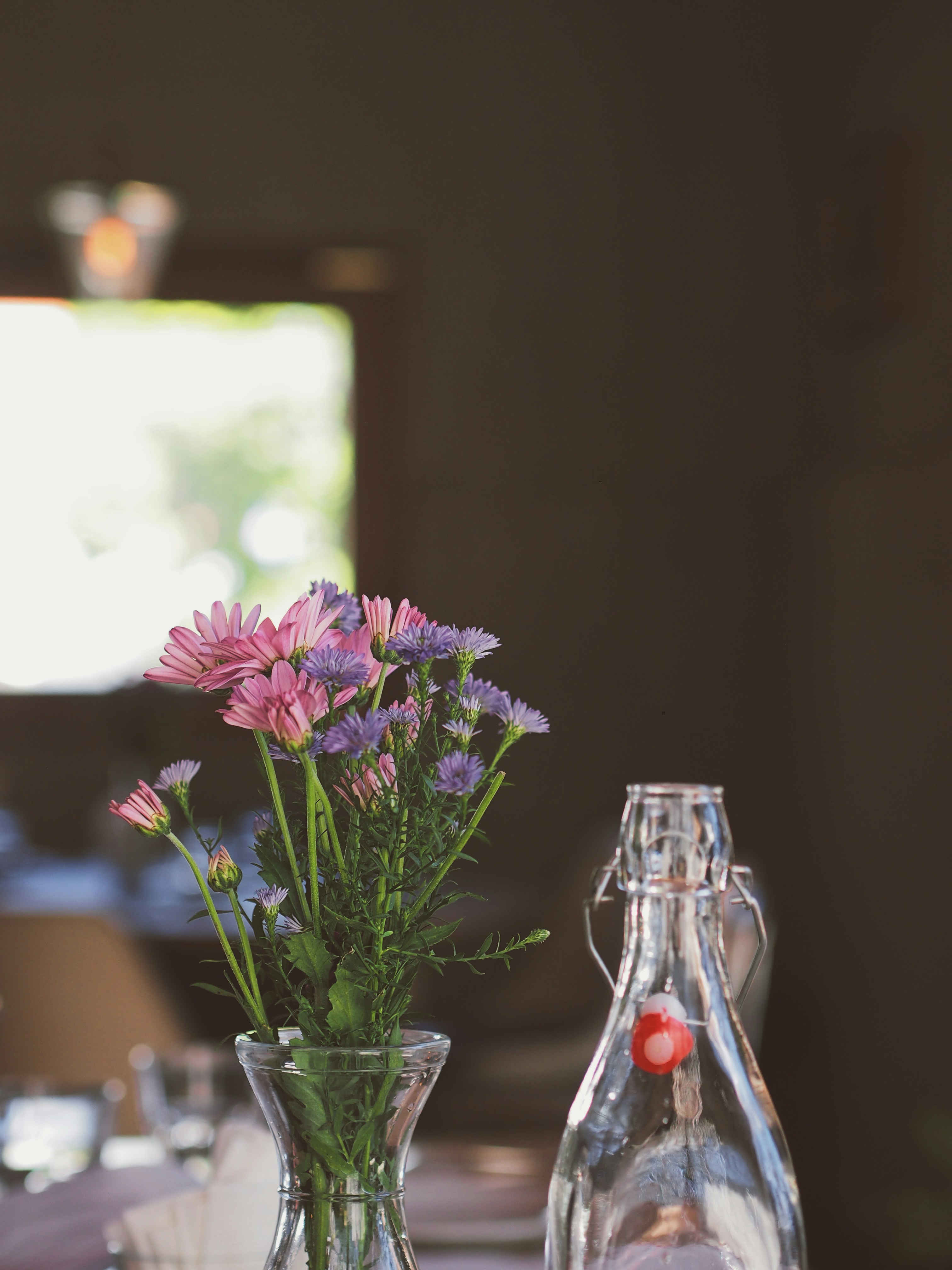 Grayscale Photography Of Empty Table And Chairs Beside Glass Wall Photo Free Paris Image On Unsplash