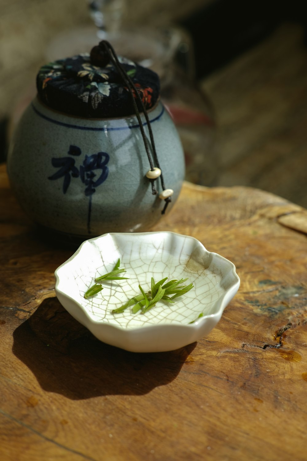 leaves and liquid in bowl on wooden surface