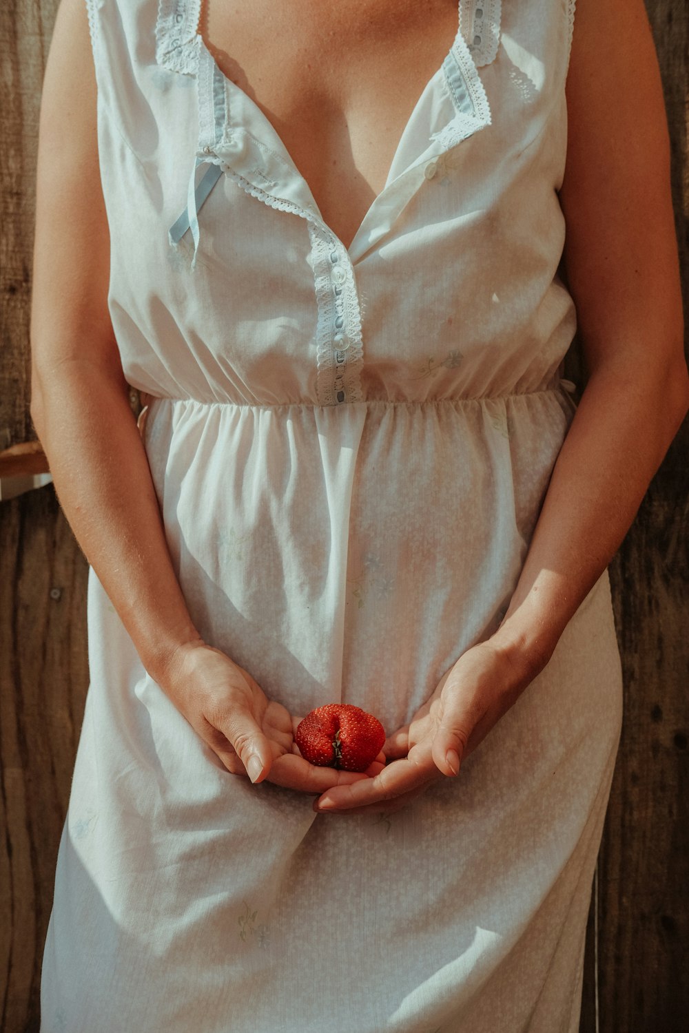 unknown person holding red fruit
