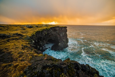 rock formation during golden hour seaside google meet background