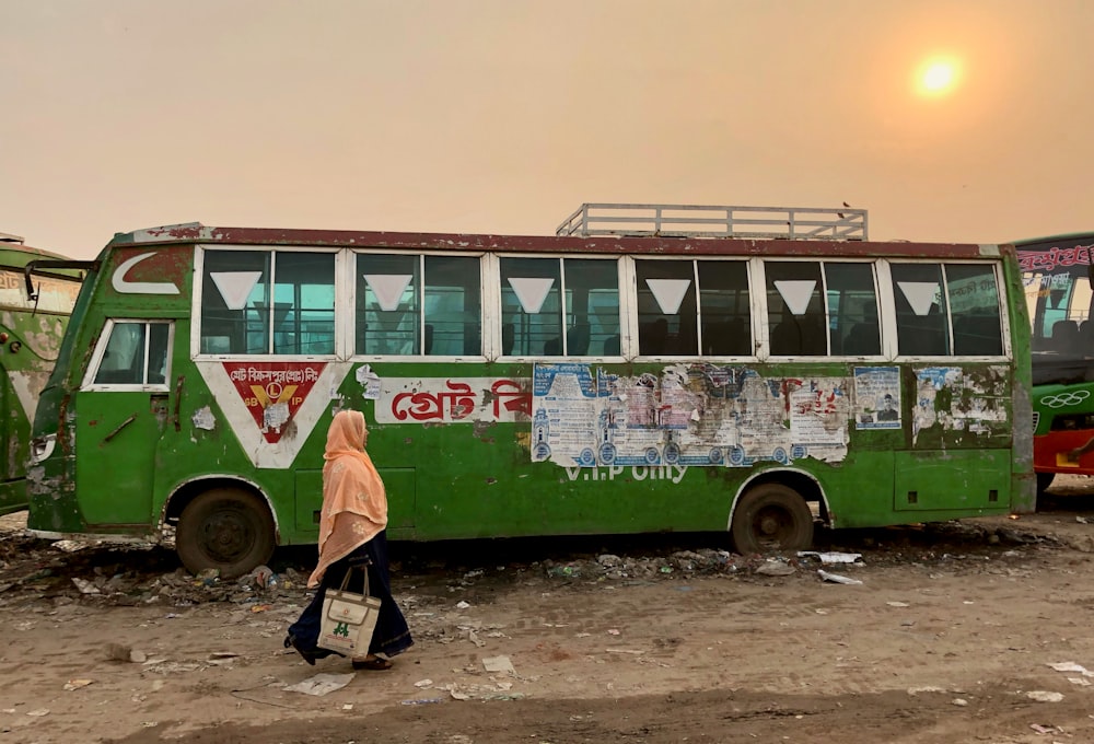 woman standing beside bus