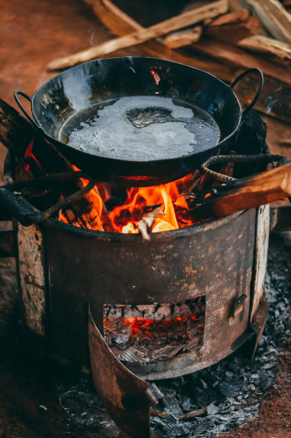 black cooking pot on top of brown wood stove