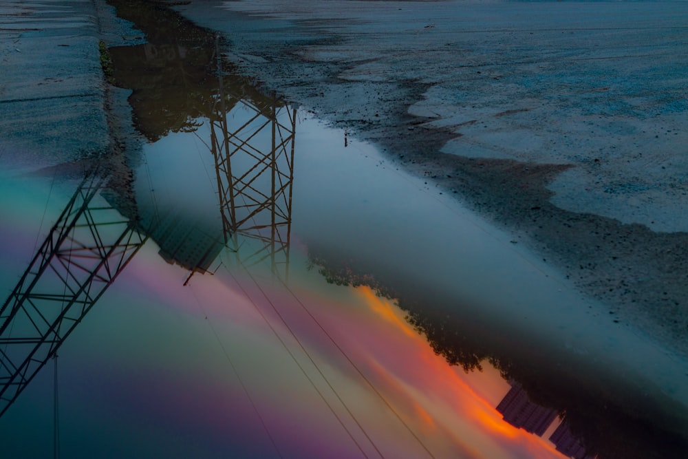 a reflection of a power line in a body of water