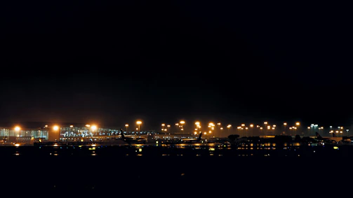 Nighttime view of a master air services facility lit with warm lights.