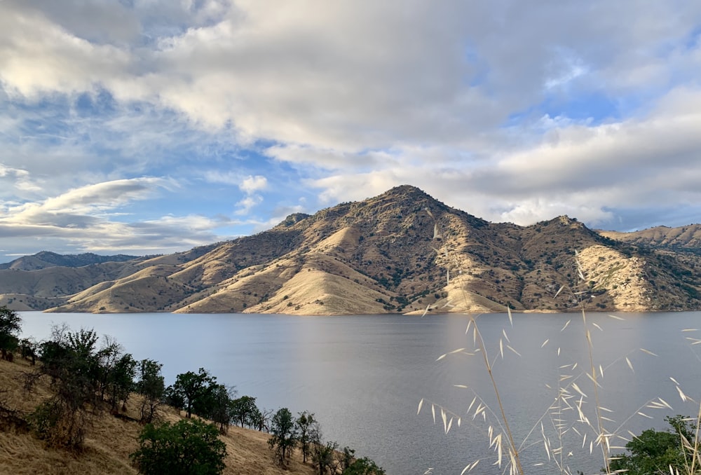 soil mountains and lake during day