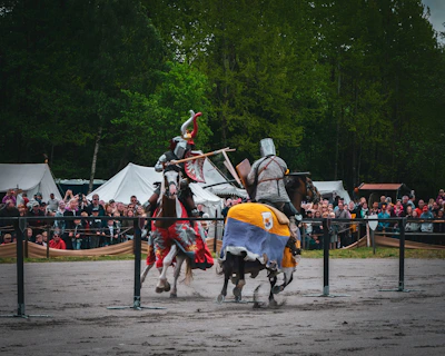 A lively scene of knights and armigers preparing for a combat demonstration.