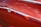Close-up of a shiny red car freshly painted with a glossy finish.