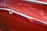 A close-up of a shiny, wrapped car showcasing vibrant color protection.