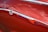 A close-up of a shiny, wrapped car showcasing vibrant color protection.