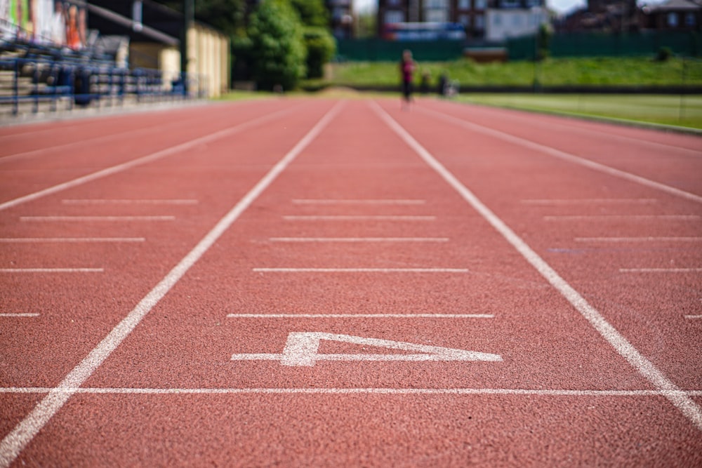 rubberized track field at daytime