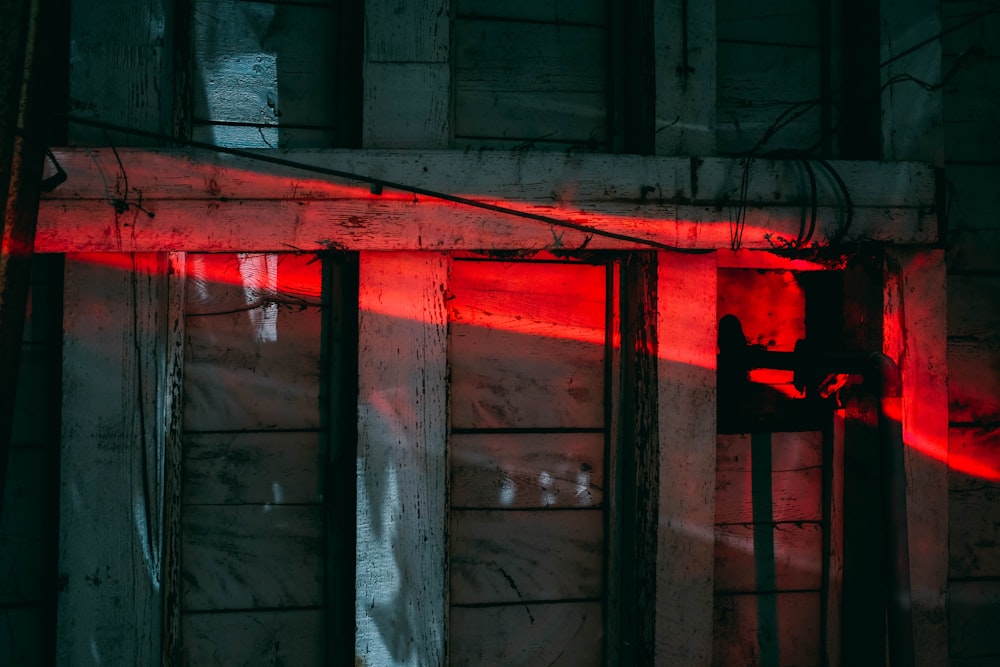 red light on brown wooden wall