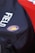 A close-up view of a bag featuring a logo with a lion and the words 'ROYALS FC'. The bag is primarily dark in color with the word 'FIELD' printed on it in white. A bright red colored background is partially visible.