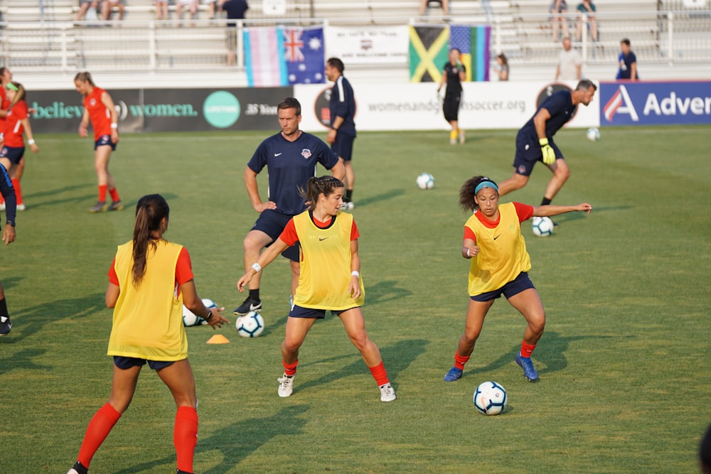 group of girls playing soccer at daytime