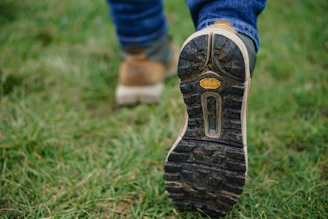 person wearing brown-and-black shoes