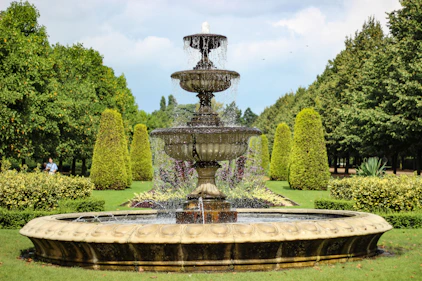 A designer fountain surrounded by lush greenery.