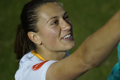 A smiling individual looking hopeful, representing emotional recovery.