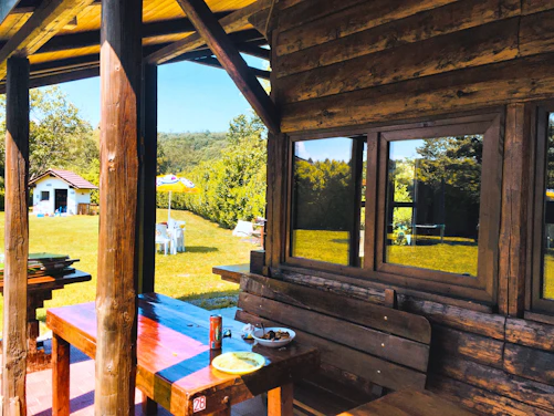 A cozy wooden wendy house nestled in a sunny Western Cape garden.