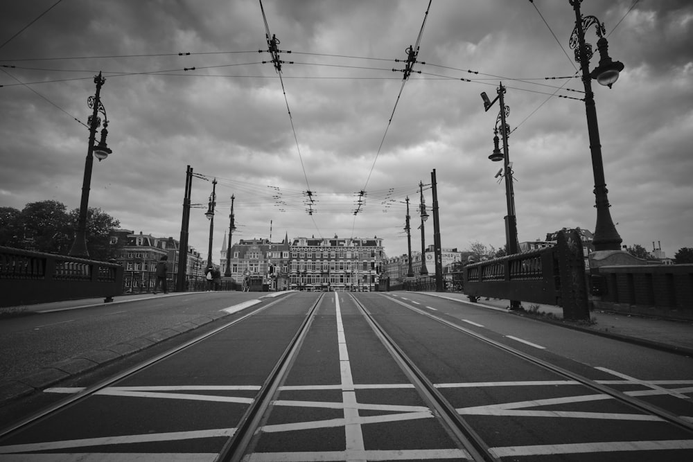 grayscale photography of road towards building