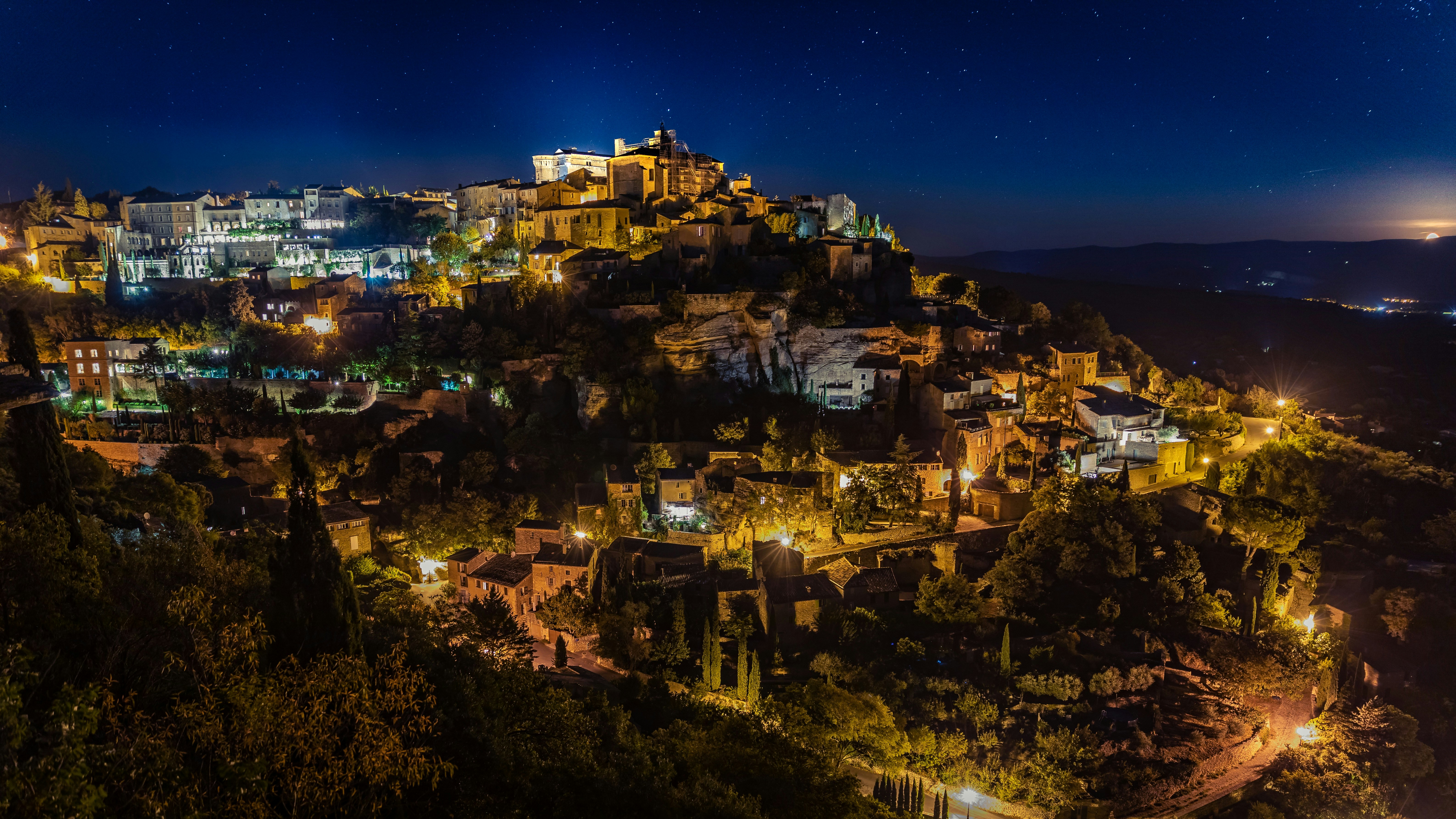 aerial view of lighted houses during night time