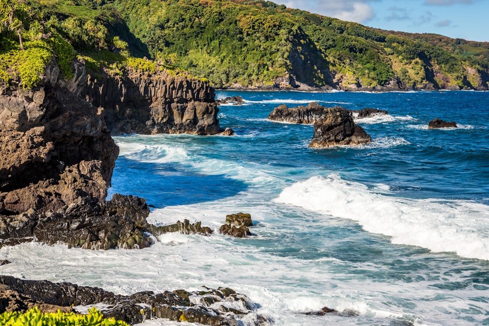 body of water crashing on rocks