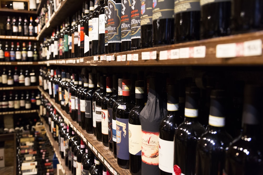 assorted wine bottle lot displaying on rack