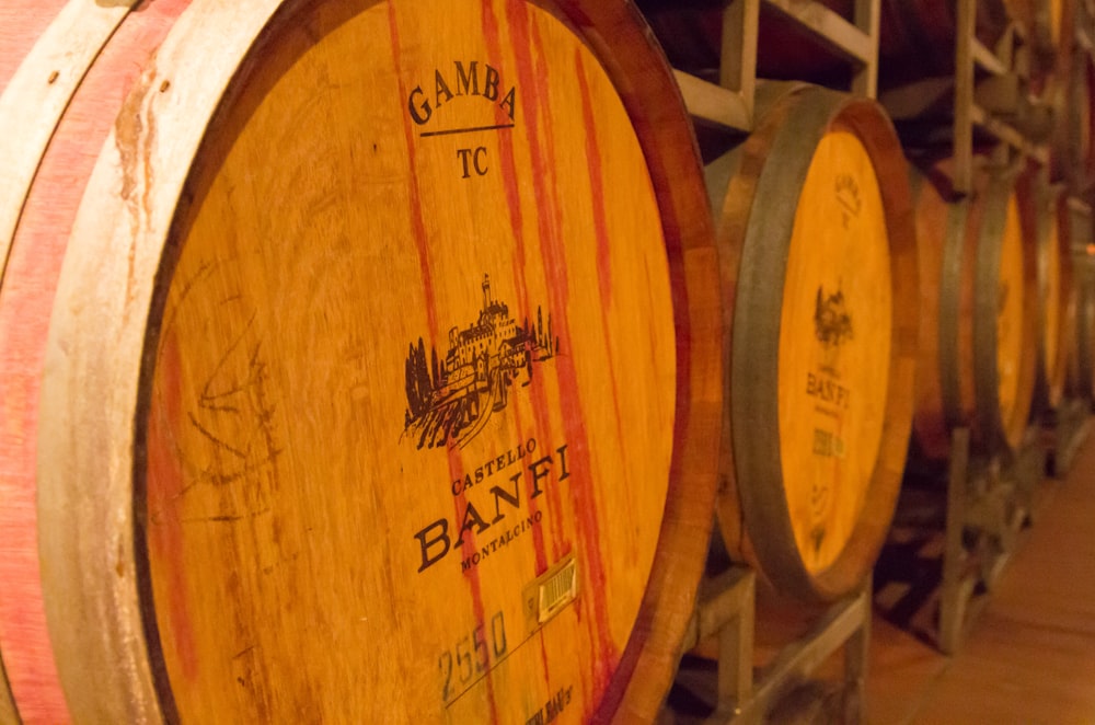 brown wooden barrels on rack