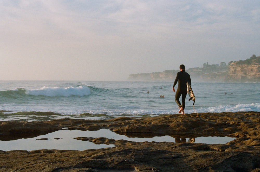 man wearing black wet suit