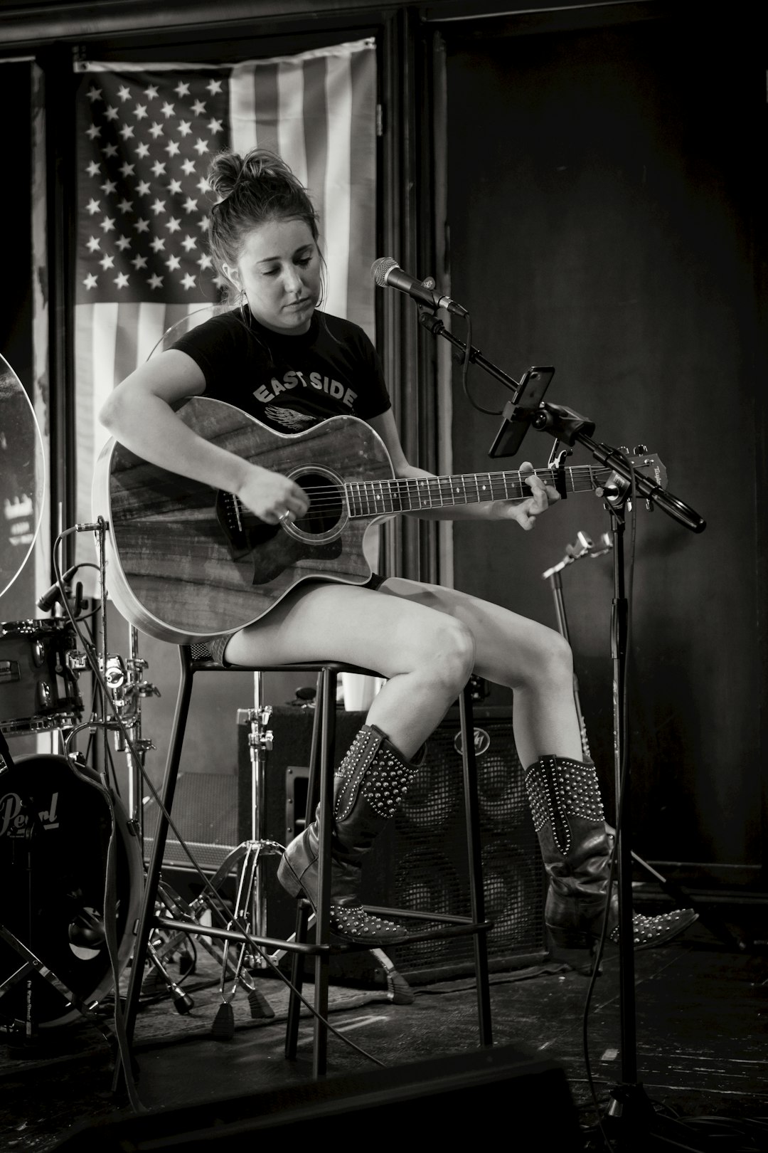 woman playing guitar grayscale photo
