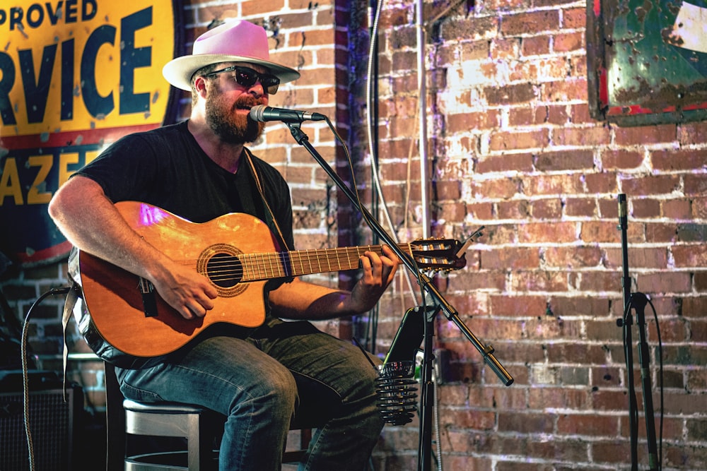 man playing guitar while singing