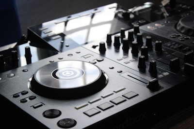 Close-up of professional DJ equipment neatly arranged on a sleek black table.