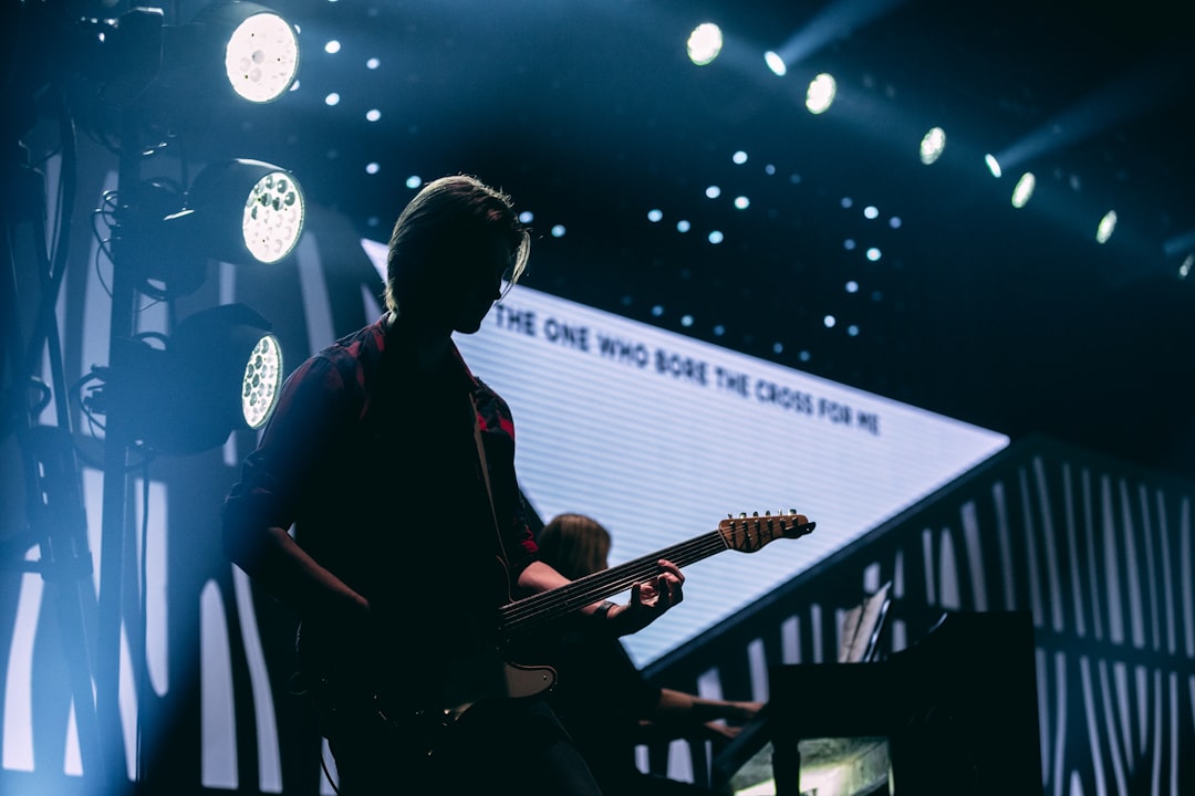 man playing guitar on stage