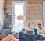 three men using MacBooks