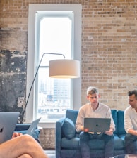 three men using MacBooks