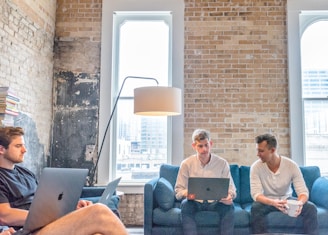 three men using MacBooks