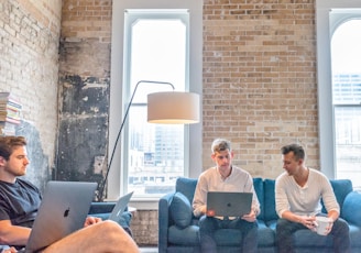 three men using MacBooks