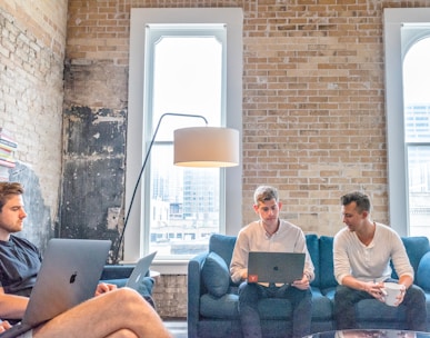 three men using MacBooks