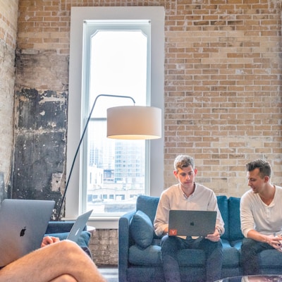 three men using MacBooks