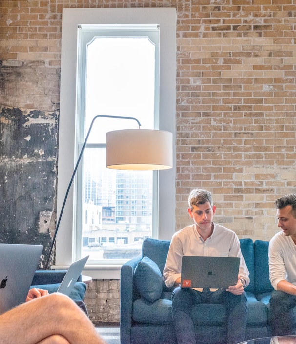 three men using MacBooks