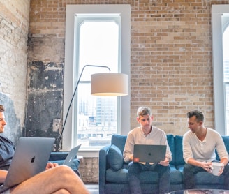 three men using MacBooks