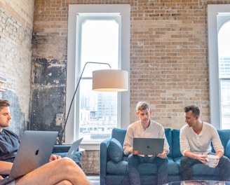 three men using MacBooks