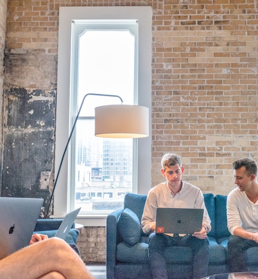 three men using MacBooks