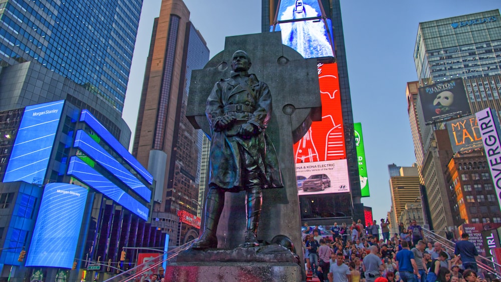 gray concrete statue surrounded by people during daytime