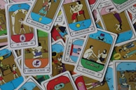 Close-up of colorful cartas ciganas spread out on a wooden table.