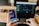 person using phone and laptop computer