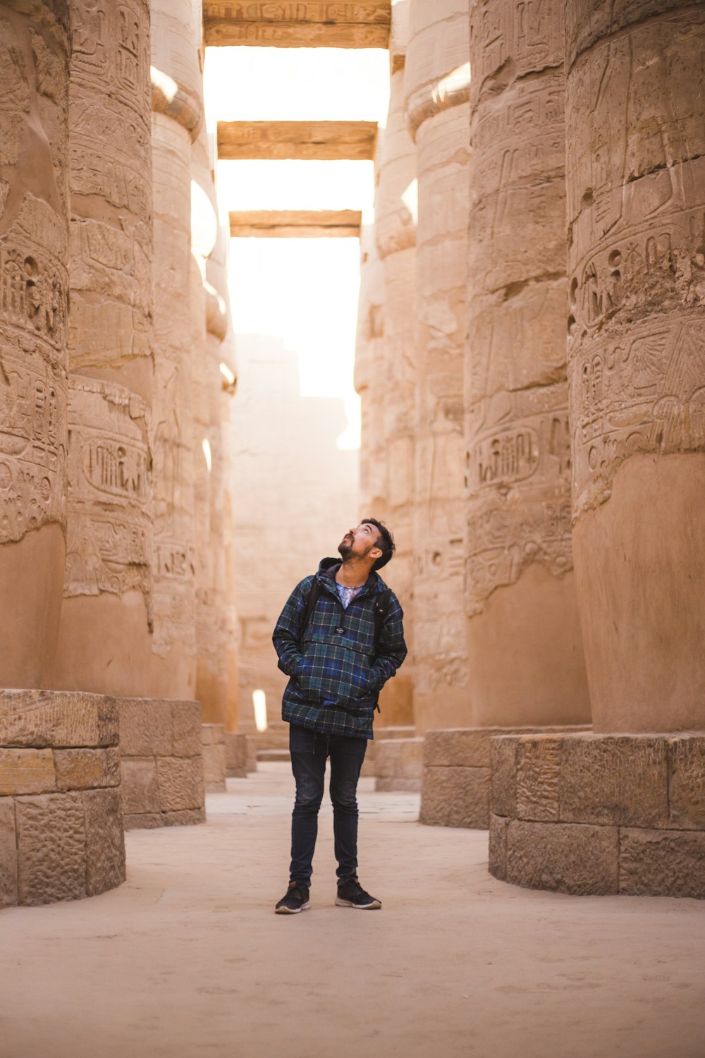 man standing between pillars