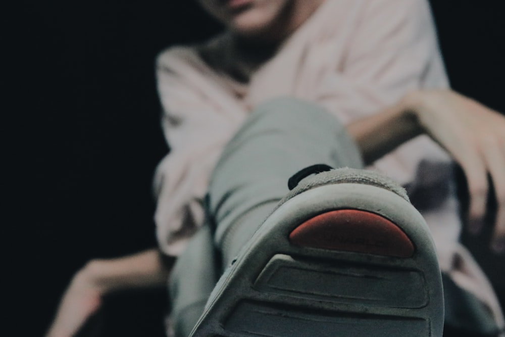 selective focus photography of gray shoe